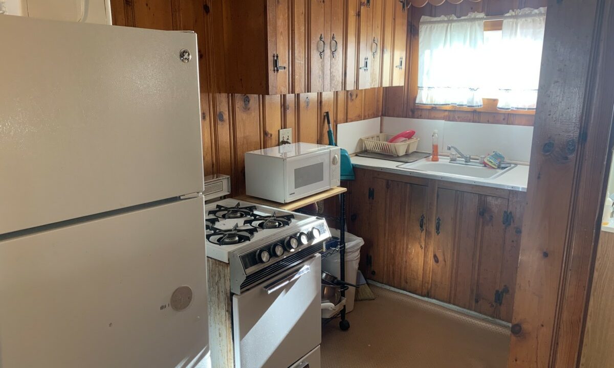 a kitchen with a stove, refrigerator and sink.