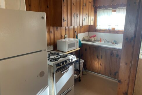 a kitchen with a stove, refrigerator and sink.