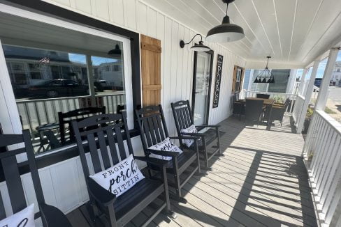 a porch with chairs and a lamp on it.