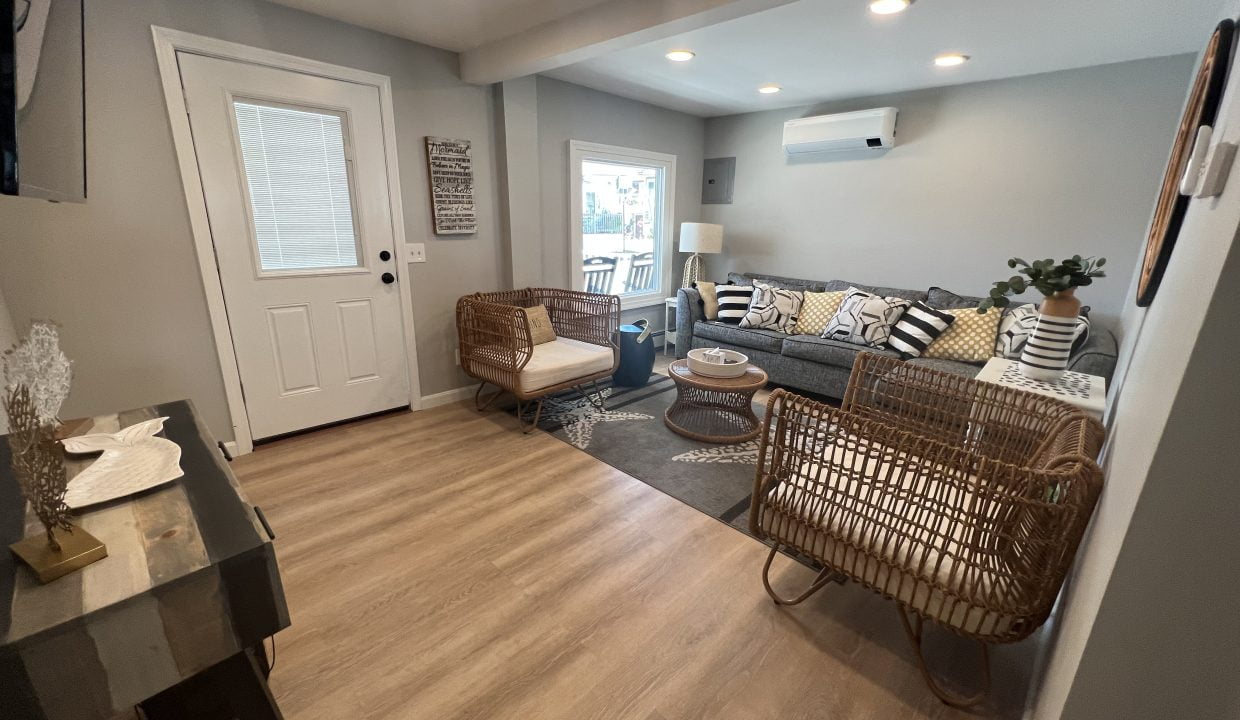 a living room filled with furniture and a flat screen tv.