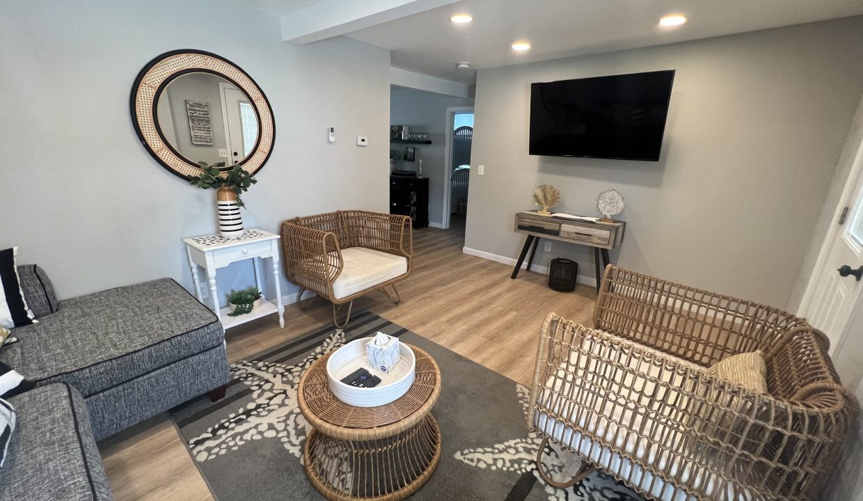 a living room filled with furniture and a flat screen tv.