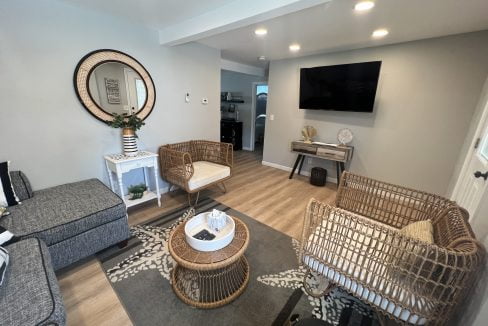 a living room filled with furniture and a flat screen tv.