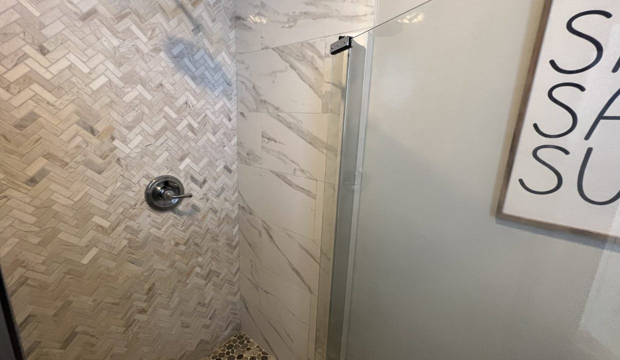 a walk in shower sitting next to a white toilet.