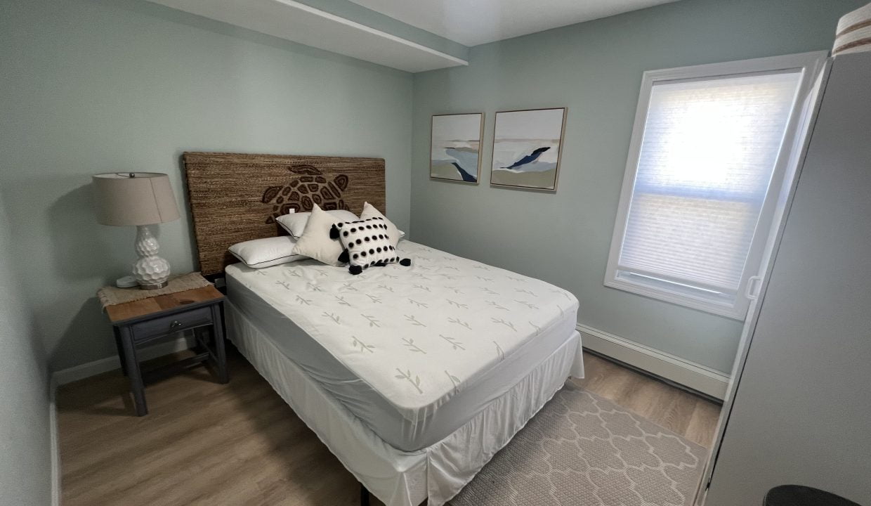 a bed sitting in a bedroom next to a window.