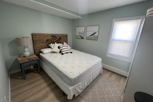 a bed sitting in a bedroom next to a window.