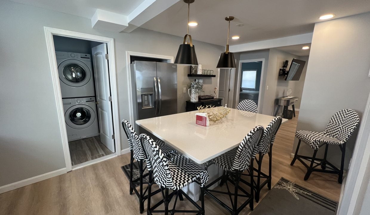a kitchen and dining room with a washer and dryer.