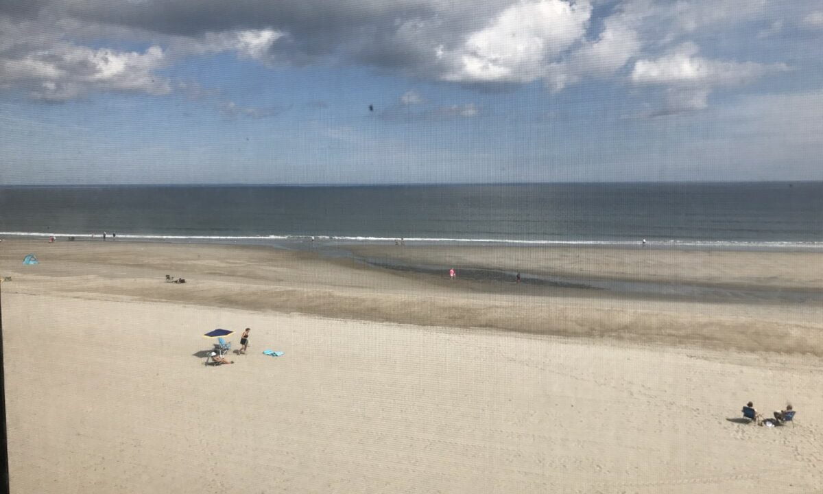 a view of a beach from a window.