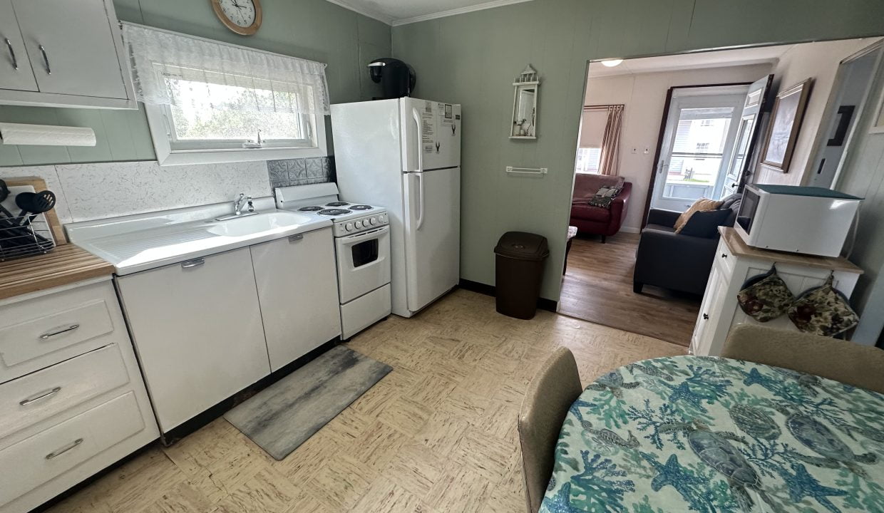 A small kitchen with a table and chairs.