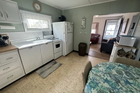 A small kitchen with a table and chairs.