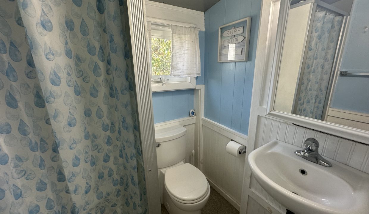 A bathroom with blue curtains and a sink.