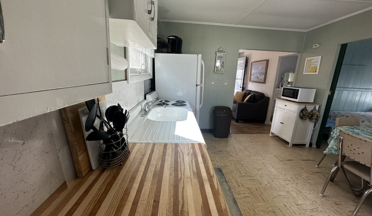 A kitchen with wood counter tops and a stove.