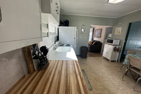 A kitchen with wood counter tops and a stove.