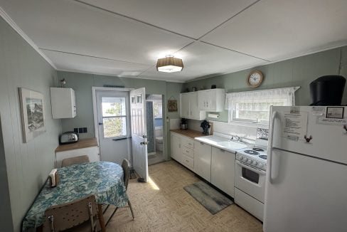 A kitchen with a stove and refrigerator.