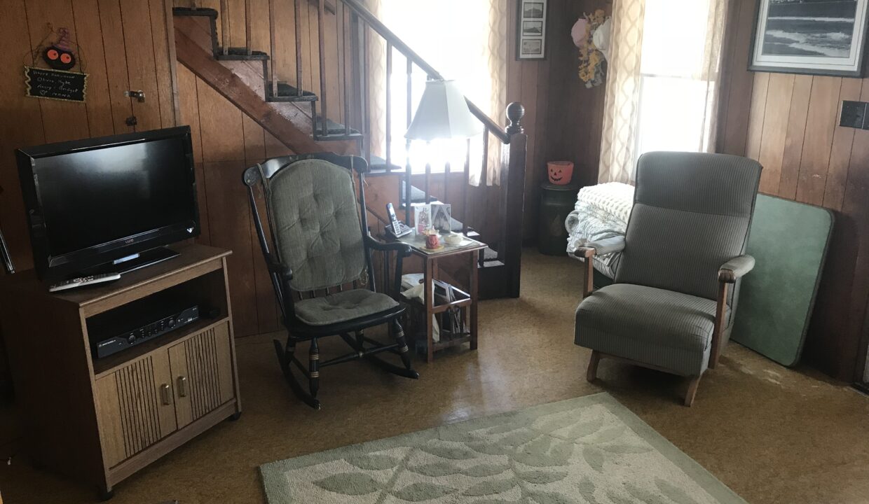 a living room filled with furniture and a flat screen tv.