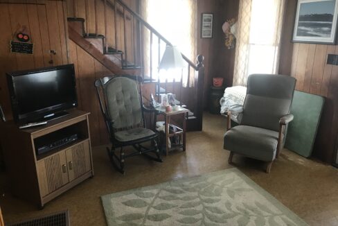 a living room filled with furniture and a flat screen tv.