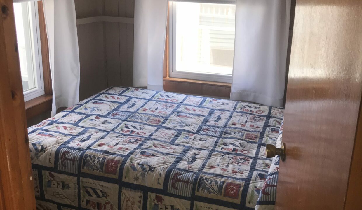 a bed sitting in a bedroom next to a window.