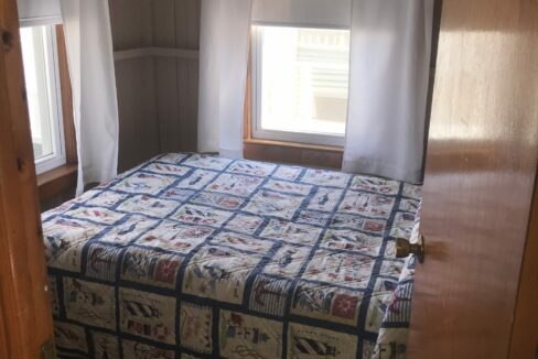 a bed sitting in a bedroom next to a window.