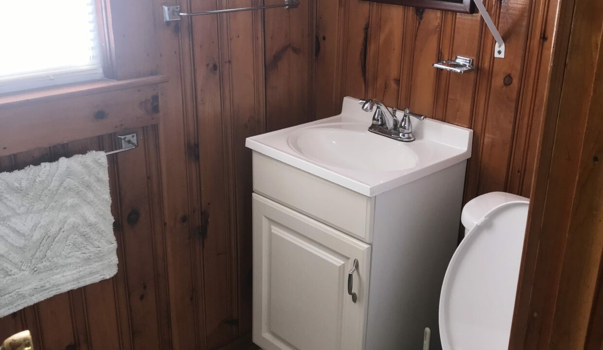 a white toilet sitting next to a white sink.