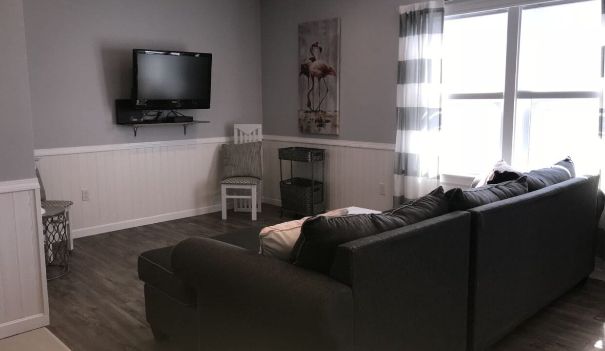 a living room filled with furniture and a flat screen tv.