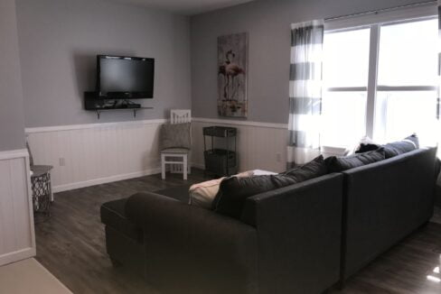 a living room filled with furniture and a flat screen tv.