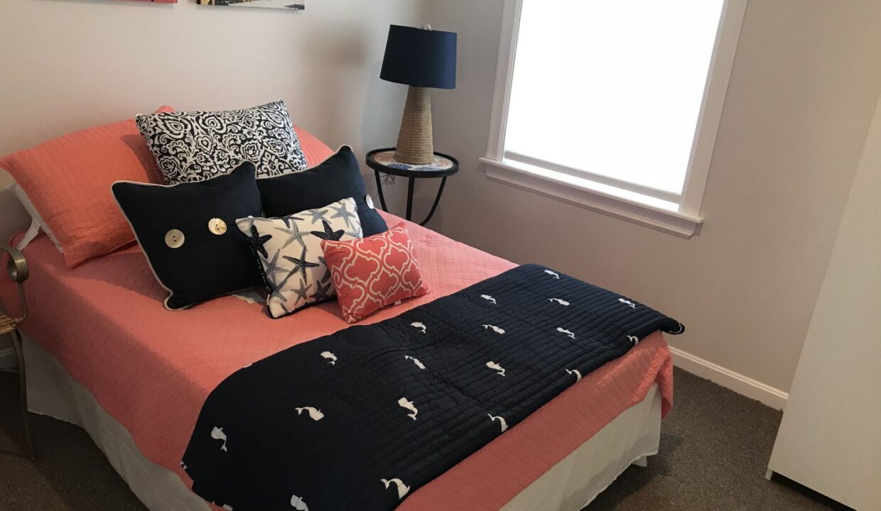 a bedroom with a bed and a lamp.