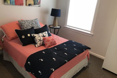 a bedroom with a bed and a lamp.