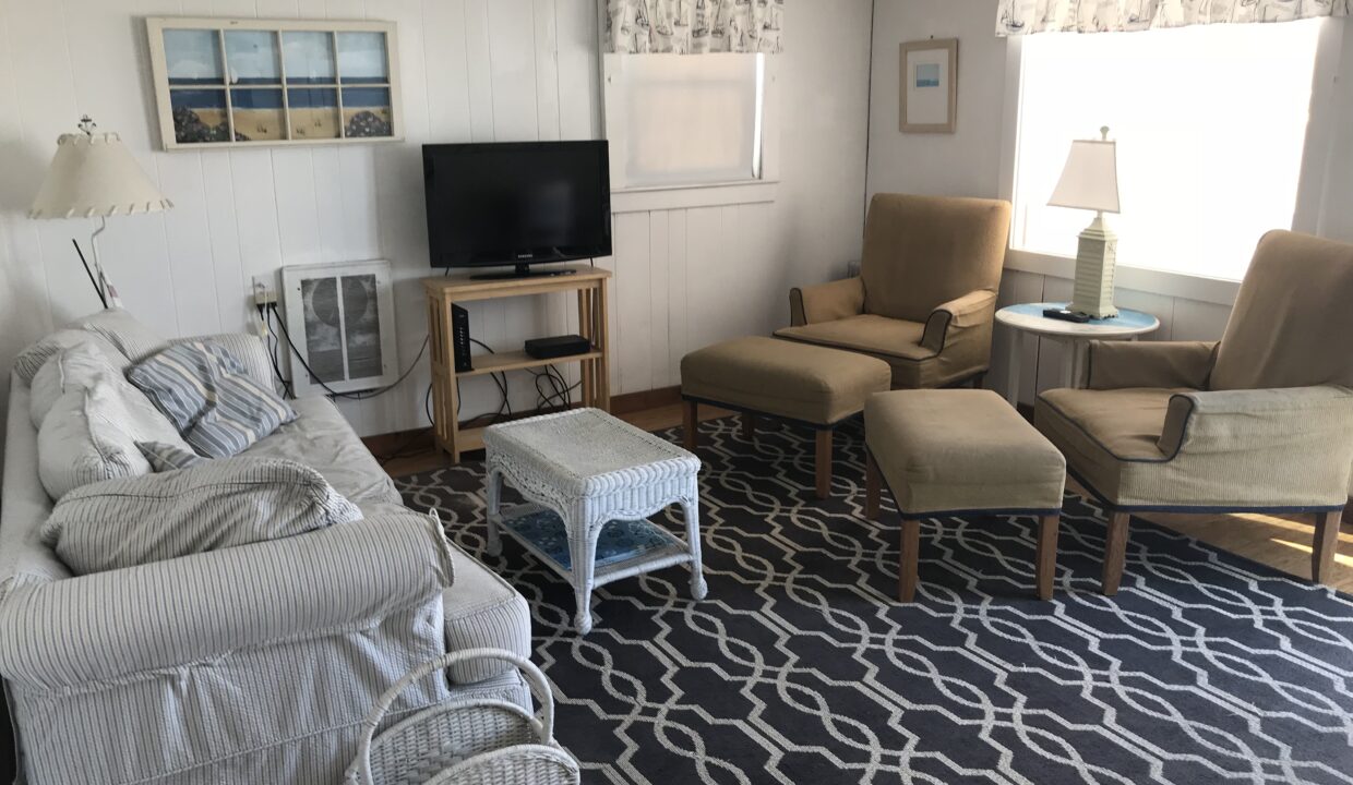 a living room filled with furniture and a flat screen tv.