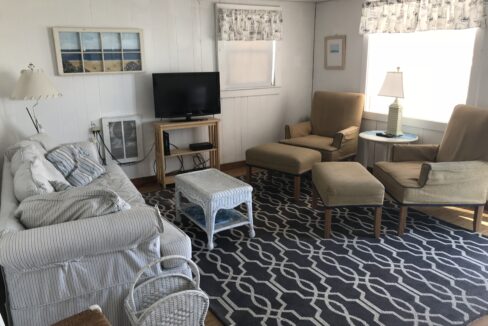 a living room filled with furniture and a flat screen tv.