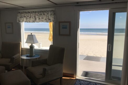 a living room filled with furniture next to a window.