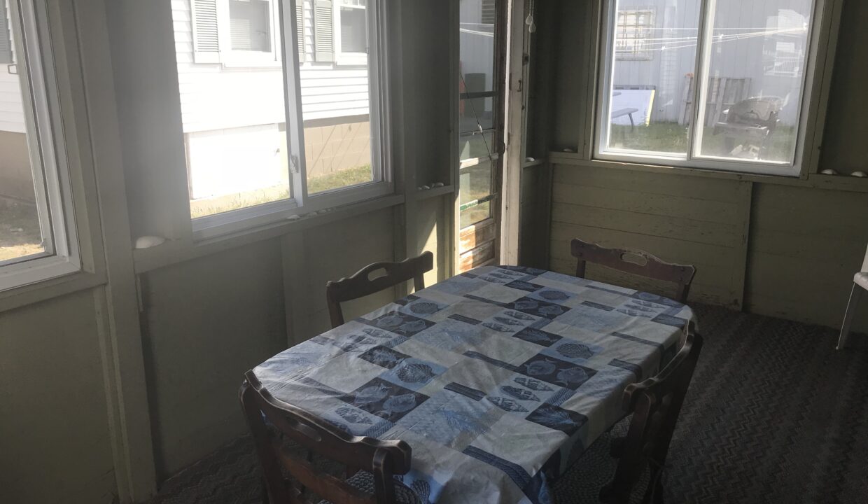 a dining room with a table and chairs.