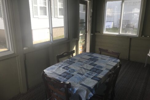 a dining room with a table and chairs.