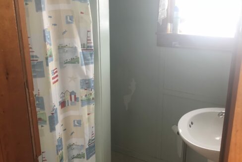 a bathroom with a sink and a shower curtain.