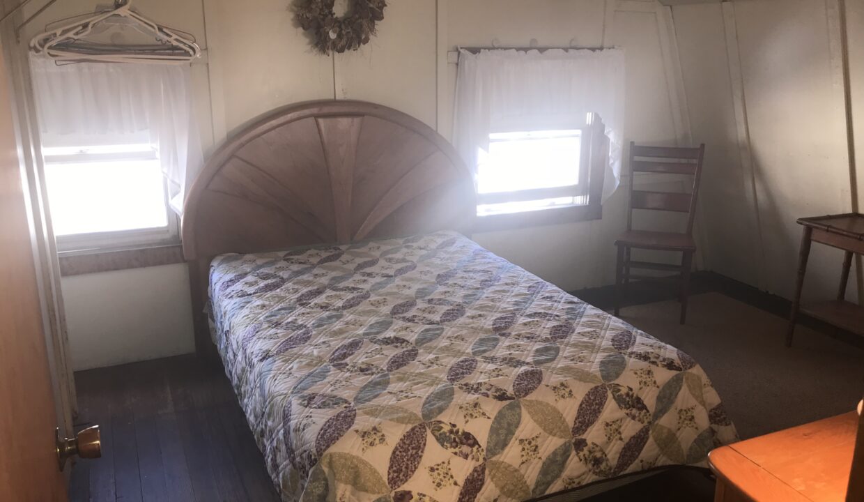 a bed sitting in a bedroom next to a window.