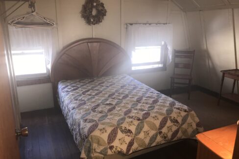 a bed sitting in a bedroom next to a window.