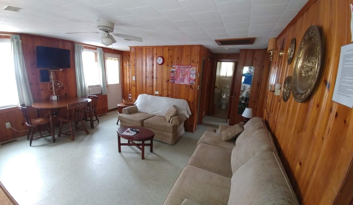 a living room filled with furniture and a flat screen tv.