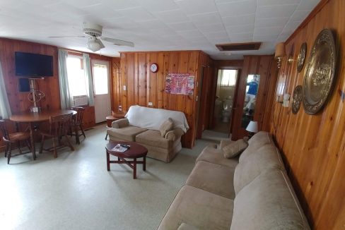 a living room filled with furniture and a flat screen tv.