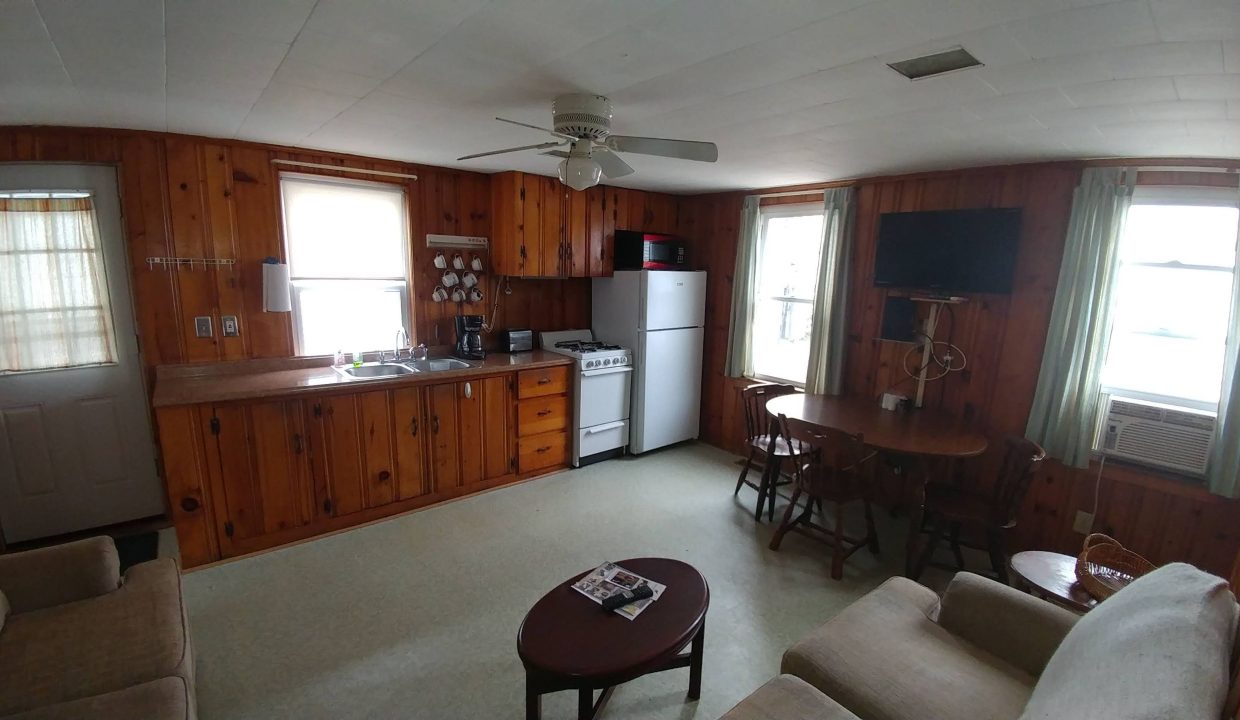 a living room with a couch a table and a tv.