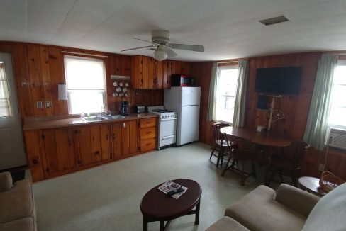 a living room with a couch a table and a tv.