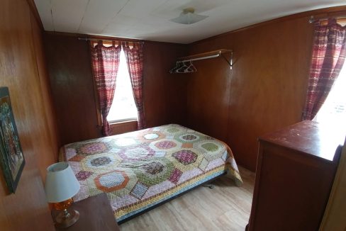 a bedroom with a bed and a dresser.