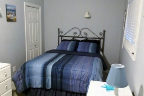 a bedroom with a bed and a dresser.