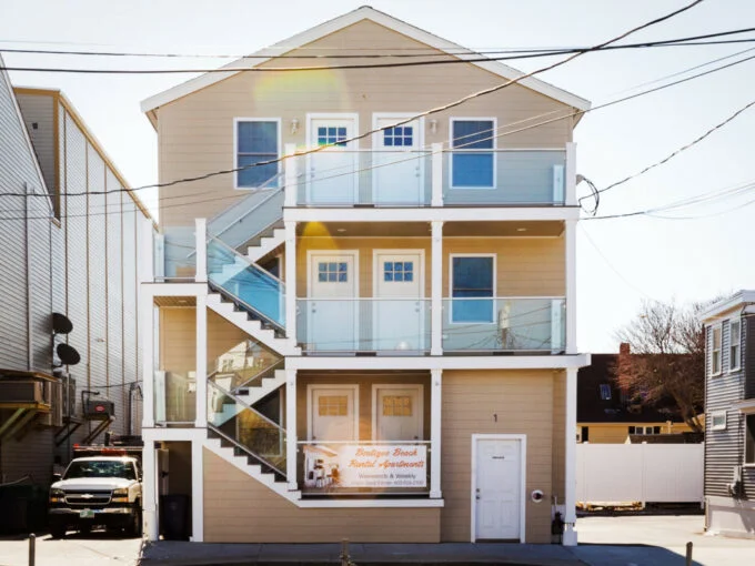 a two story house with balconies on the second floor.