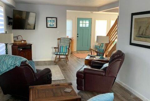 a living room filled with furniture and a flat screen tv.