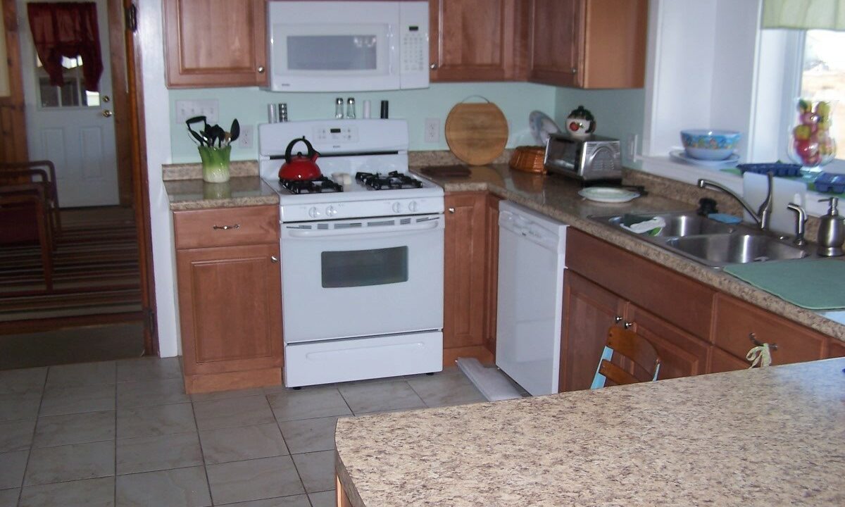 a kitchen with a white stove top oven.