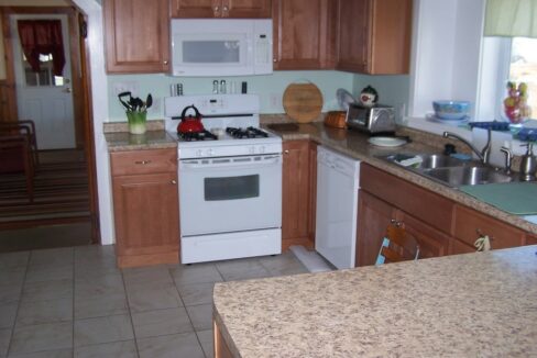 a kitchen with a white stove top oven.