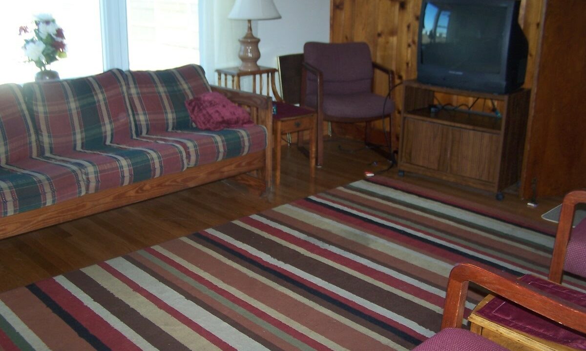 a living room filled with furniture and a flat screen tv.