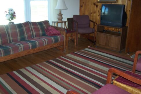 a living room filled with furniture and a flat screen tv.