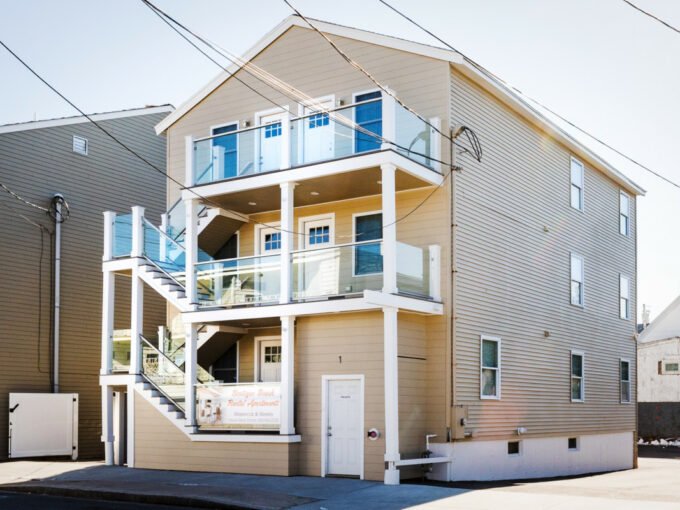 a two story apartment building with balconies and balconies on the second.