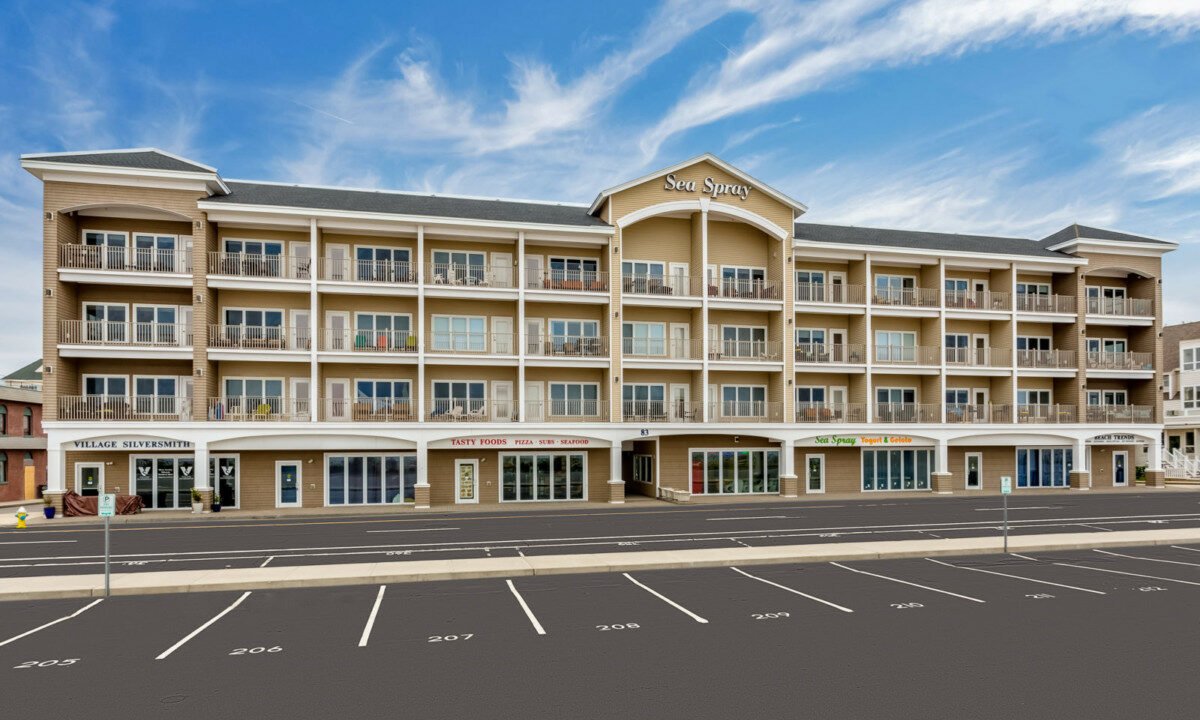 an empty parking lot in front of a hotel.