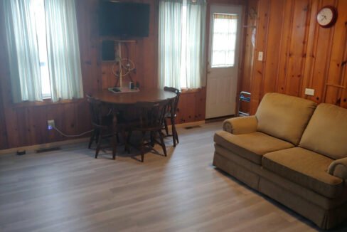 a living room filled with furniture and a flat screen tv.