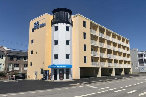 a yellow and white building with a blue awning.